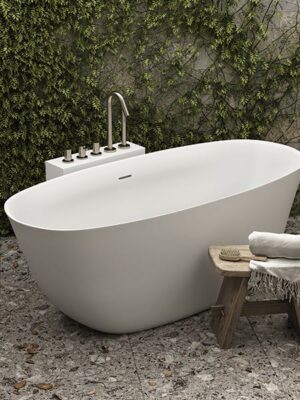 Freestanding bathtub in White Stonage model Camilla by MOMA Design, with Corian tower for faucets