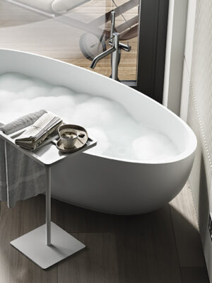 side detail freestanding tub in White Stonage model Giselle by MOMA Design, with Caddy accessory