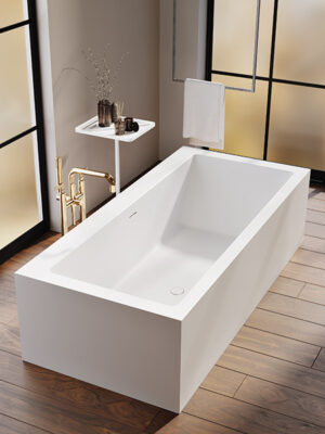 MOMA Design freestanding tub in Stonage, Ivory model with a backrest, flanked by Caddy accessory