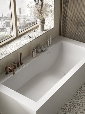 MOMA Design corner tub in Stonage, Jade model with ergonomic bowl and rim-mounted faucets