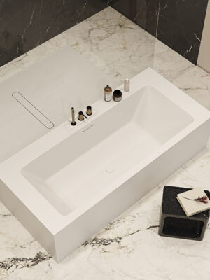 MOMA Design center-mounted bathtub in Stonage, Platinum model with double backsplash and rim-mounted faucets, flanked by floor-level shower tray model Verve