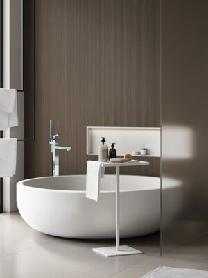 freestanding bathtub in White Stonage model Gold by MOMA Design with Caddy towel rack accessory on ceiling model Servetto