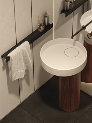 Line towel bar in matt black lacquered aluminum next to Tower Oyster model pedestal sink with rosewood base by MOMA Design