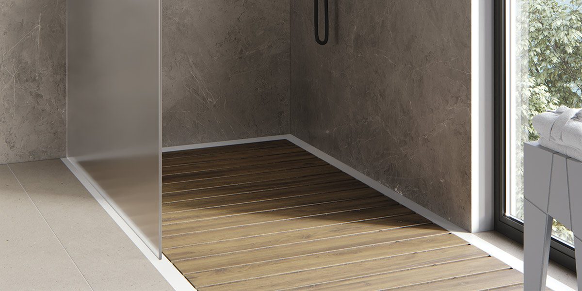 copertina2-one-shower-piatto-doccia-in-white-stonage piatto doccia ad angolo MOMA Design modello One Shower con doghe in teak, vetro fisso e sgabello Tangram